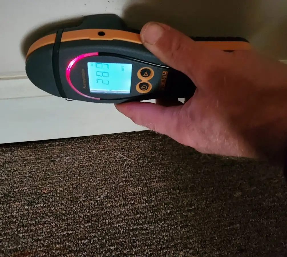 Moisture detection at baseboard during Storm Damage Restoration in Glenville